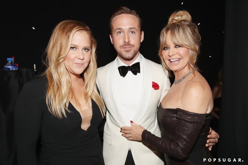 Amy Schumer and Goldie Hawn held on to Ryan Gosling after his win (as anyone would).