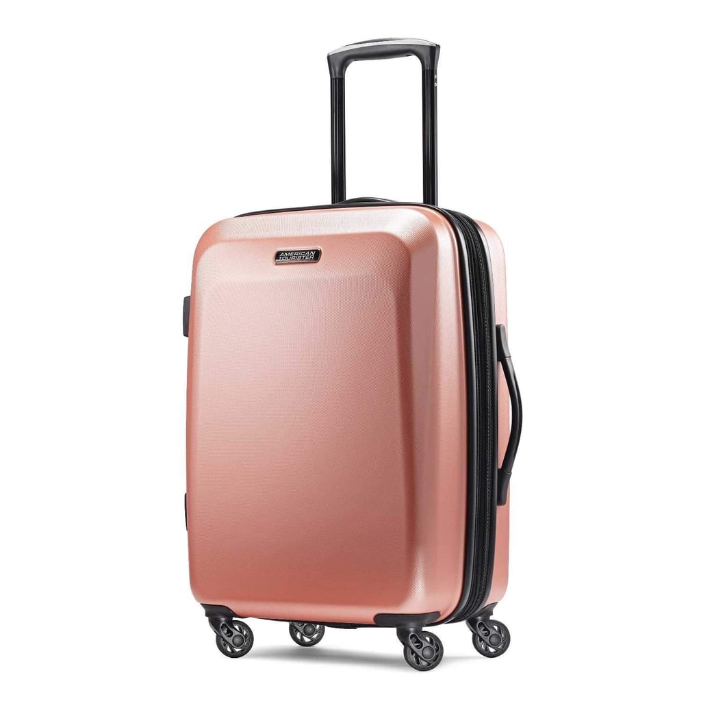"I'm a sucker for anything rose gold, so when I had the opportunity to test out this American Tourister Moonlight Spinner ($60), I jumped at the chance. I have been on the hunt for hardside luggage that's easy to carry — luckily this arrived just in time for a two-week trip to New York City. 
Not only did the suitcase look beautiful, but I was shocked by how much room the 21-inch design had inside. The black and gold lining was a pretty touch, too. I was able to fit a couple of jackets, three pairs of shoes, and plenty of outfits in the space. There's also a mesh divider so you can keep items separated, as well as a hidden pocket in case you want certain belongings stashed away privately.
If you need any extra space, the zipper expands 1.5 inches — that came in handy for the additional purchases I made on my trip. The wheels rotate 360 degrees, so no matter which way you're going, you'll get a smooth ride as you pull the suitcase along. Overall, I'm really happy with this spinner and would recommend it to anyone who needs new travel accessories — it gets my stamp of approval." — MCW