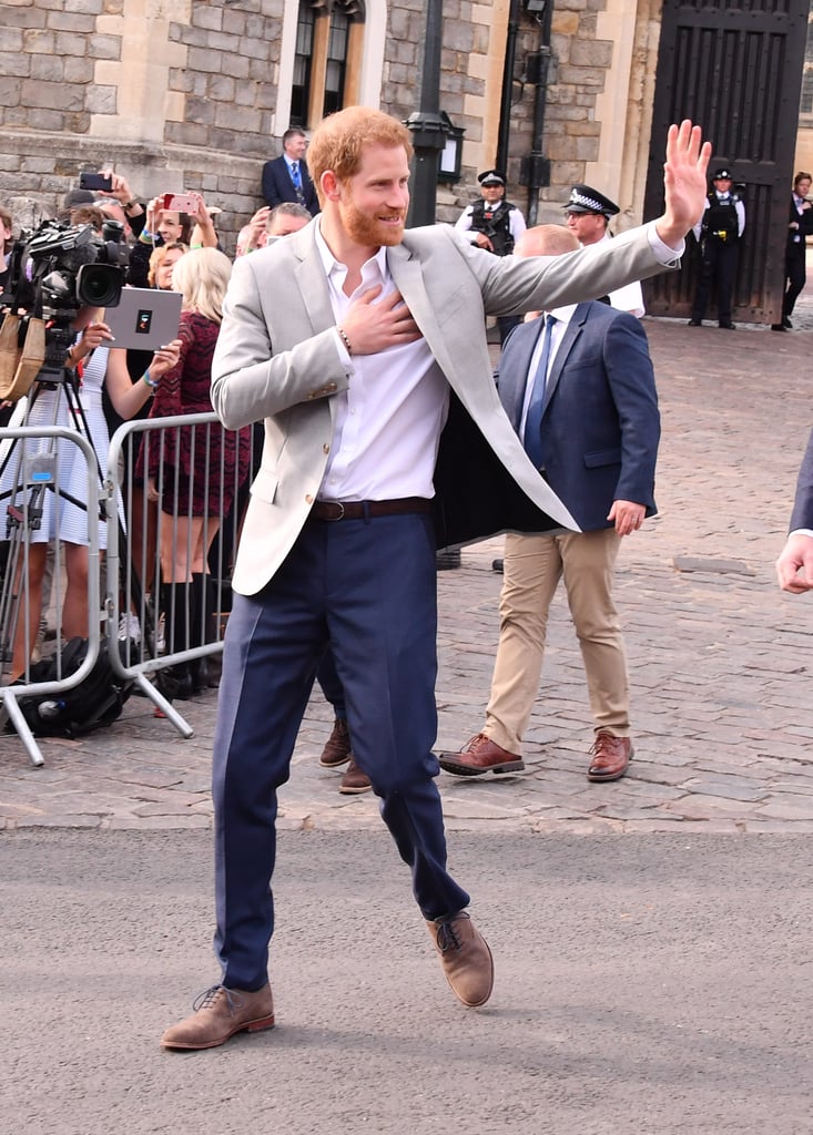 The day before his wedding to Meghan Markle, Prince Harry stepped out in a smart grey blazer to meet with members of the public who had gathered in Windsor for the celebrations.