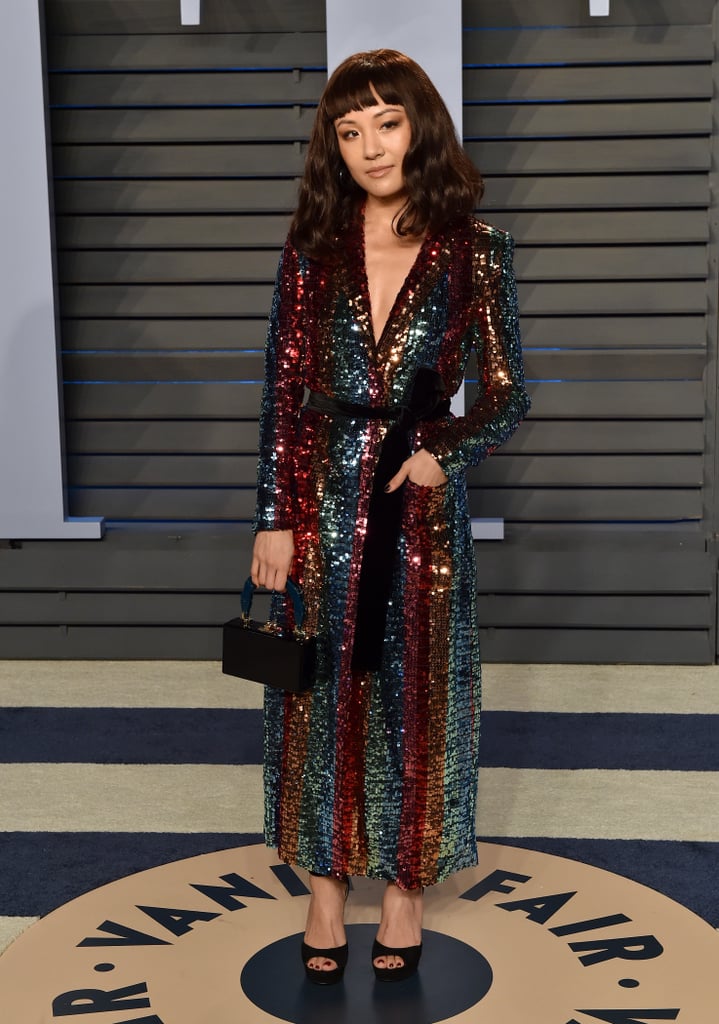 Wearing a sparkly Markarian dress, Edie Parker clutch, and Alexis Bittar jewels at the 2018 Vanity Fair Oscar Party in 2018.