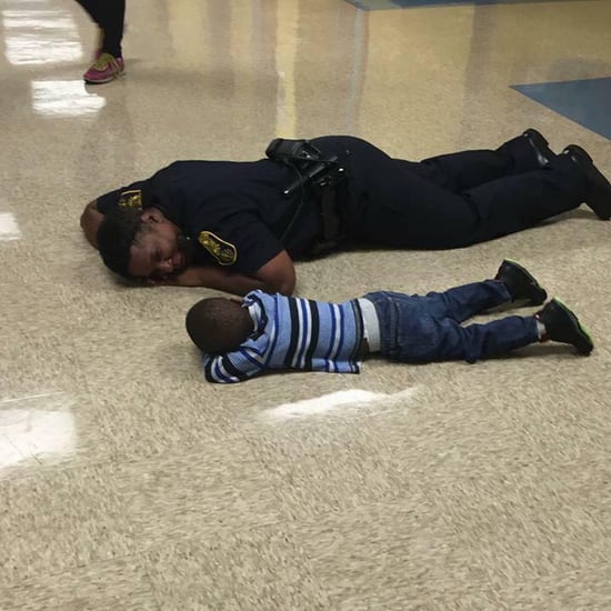 Photo of Police Officer Lying Down With Little Boy