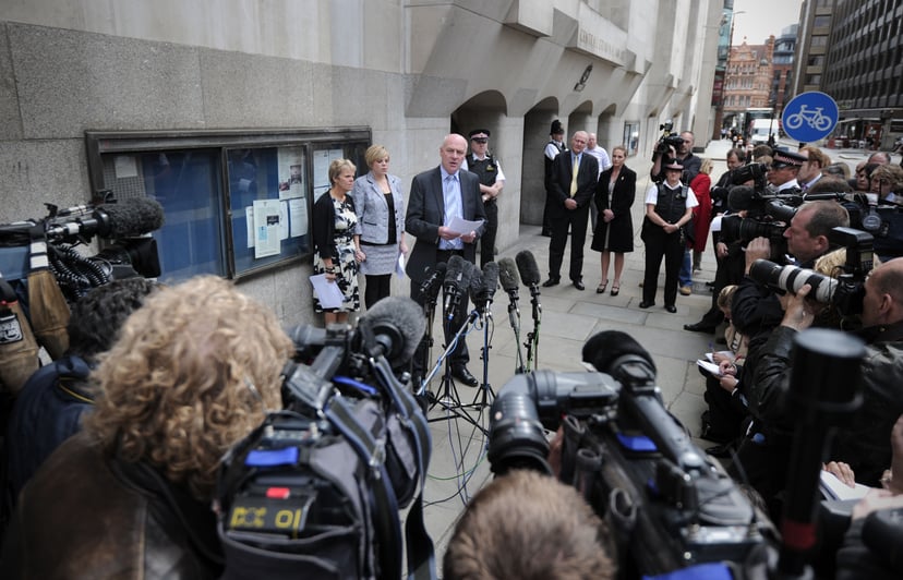 The mother and sister of murdered schoolgirl Amanda Dowler, Sally (L) and Gemma (2nd L), listen as father Bob Dowler (3rd L) reads a statement outside the Old Bailey in central London, on June 24, 2011. Surrey Police apologised today for mistakes in the M