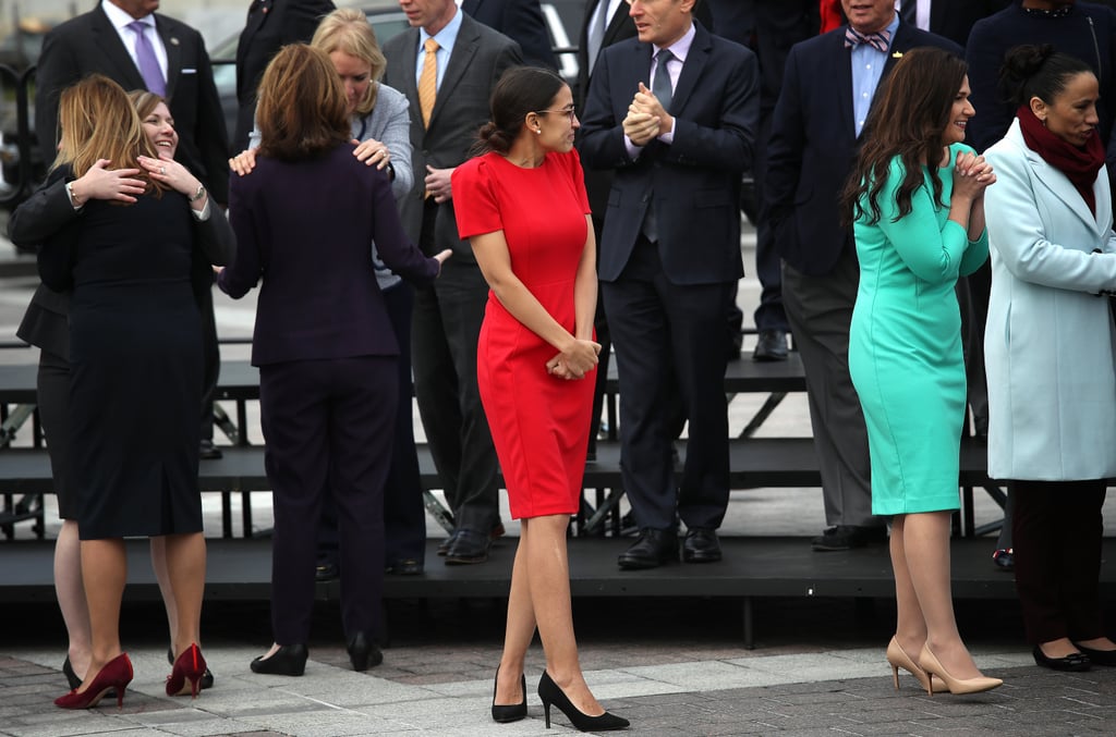 She stood out in the crowd in a red sheath dress while joining the other newly elected members of Congress for an official photo.