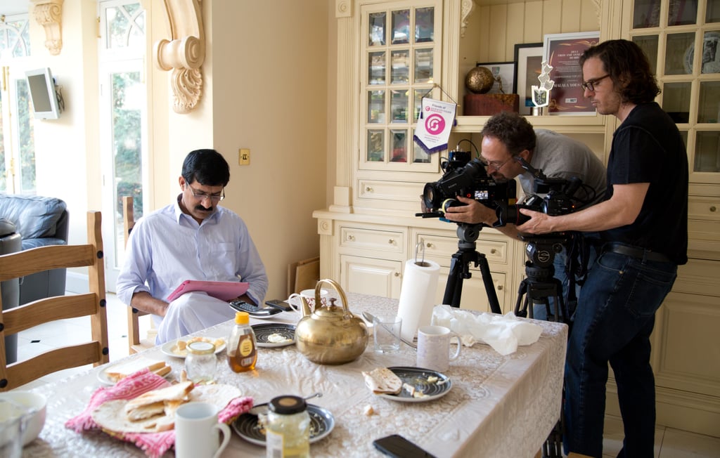 Malala's father, Zia, reads as director David Guggenheim and director of photography Erich Roland film him for He Named Me Malala.