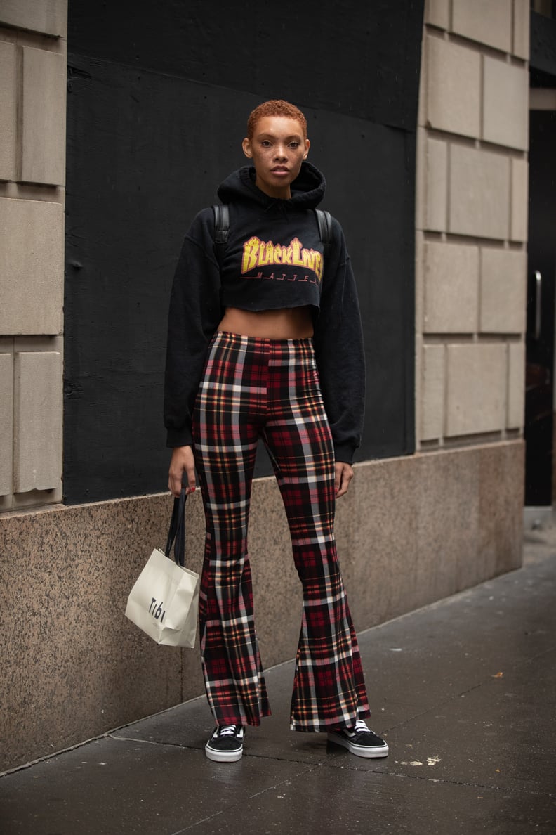 With a Cropped Graphic Hoodie and Flared Plaid Pants