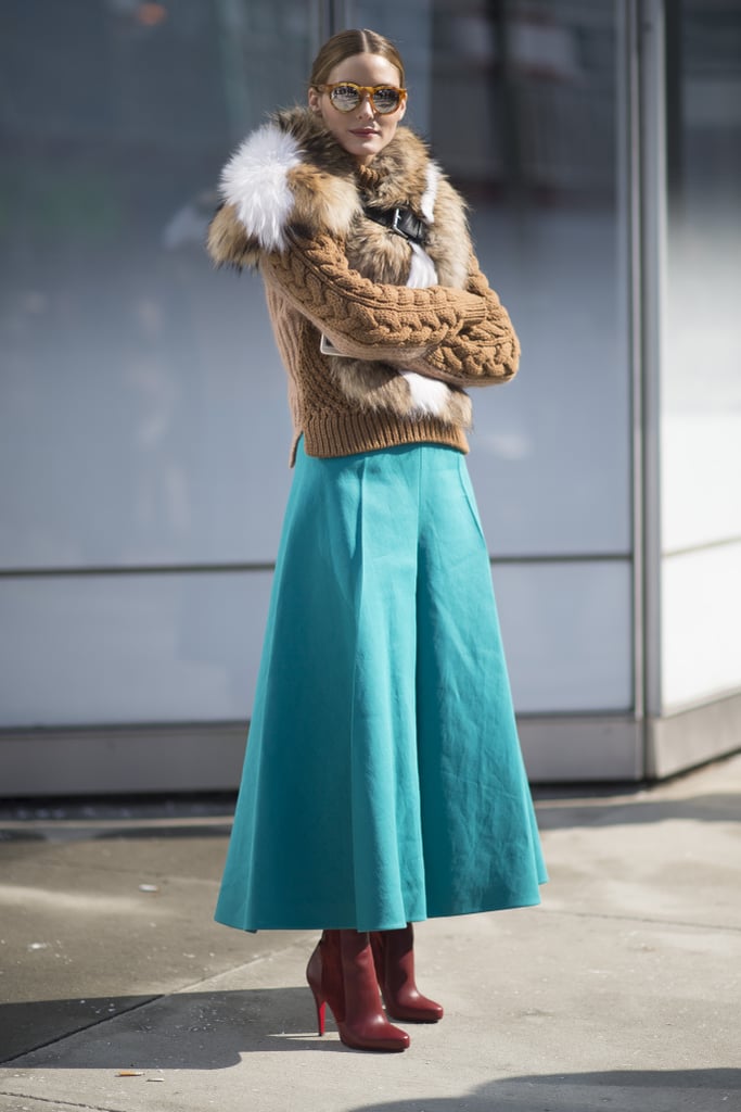 Red shoes and a teal skirt? We would be scared to try this pairing, but Olivia can make even the quirkiest combinations work. She finished off the bold style with a furry Fendi topper and Westward Leaning sunglasses while out and about during New York Fashion Week.