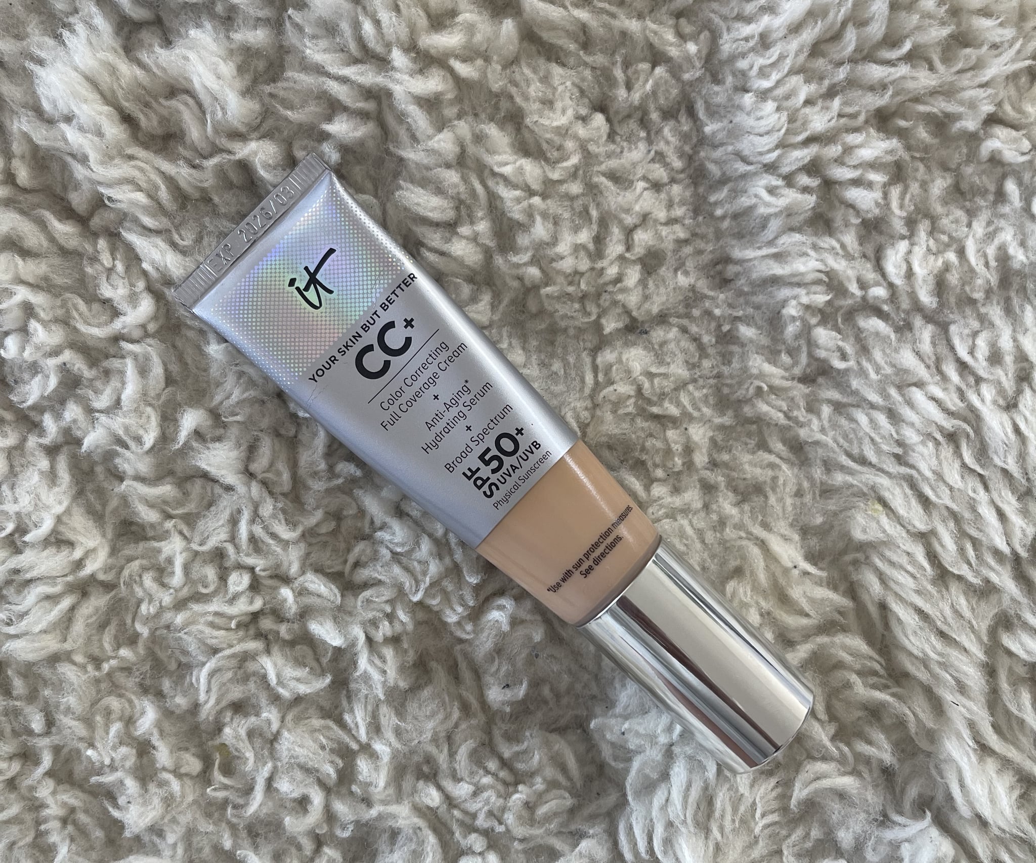 Tube of It Cosmetics CC Color Correcting Full Coverage Cream against sheepskin