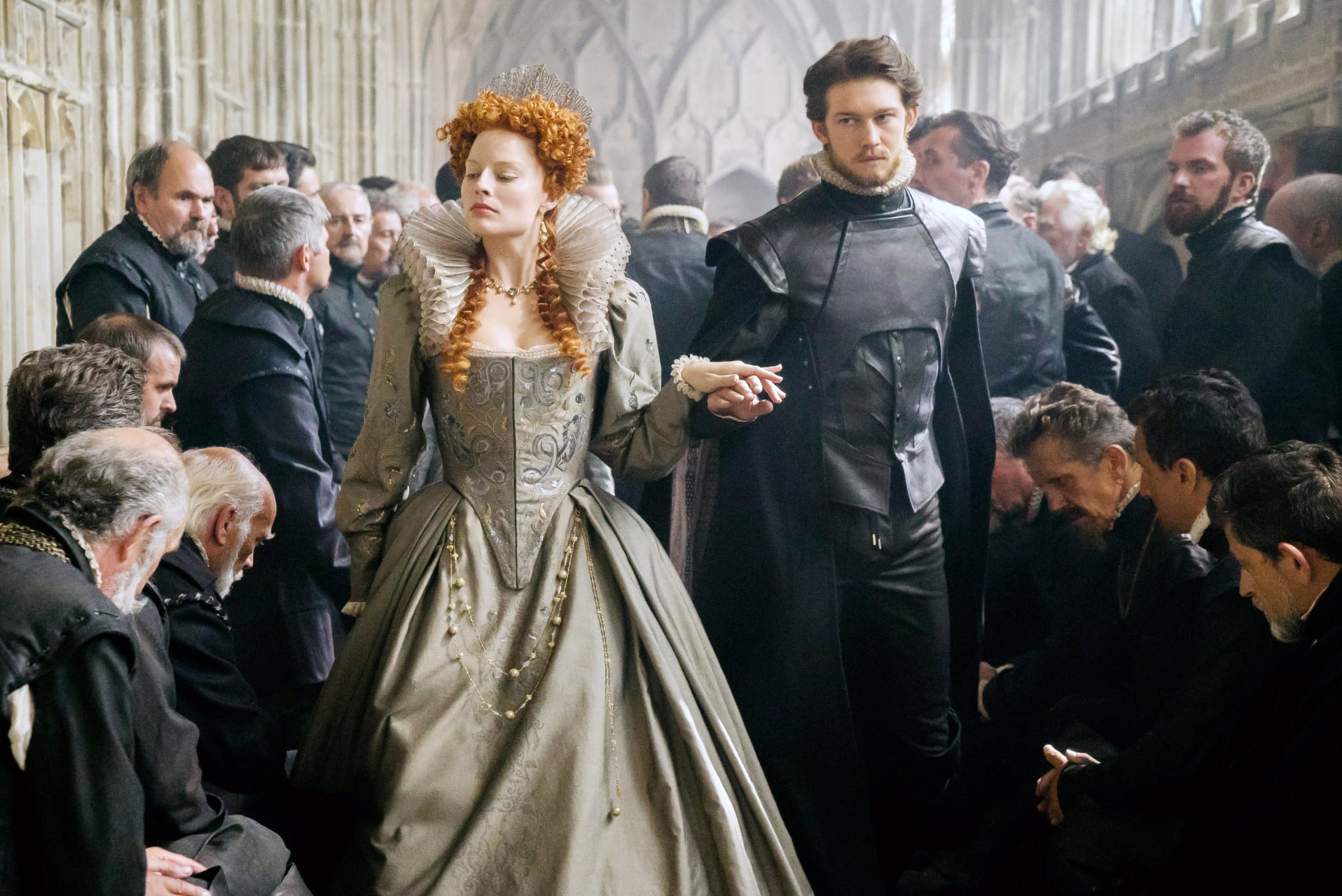 MARY QUEEN OF SCOTS, centre from left: Margot Robbie as Queen Elizabeth I, Joe Alwyn as Robert Dudley, 2018. ph: Liam Daniel.  Focus Features /Courtesy Everett Collection