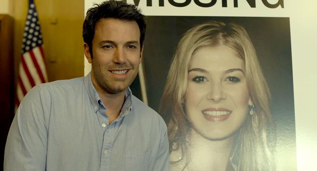 Nick (Ben Affleck) makes a mistake when he smiles smarmily in front of his wife's "Missing" poster.