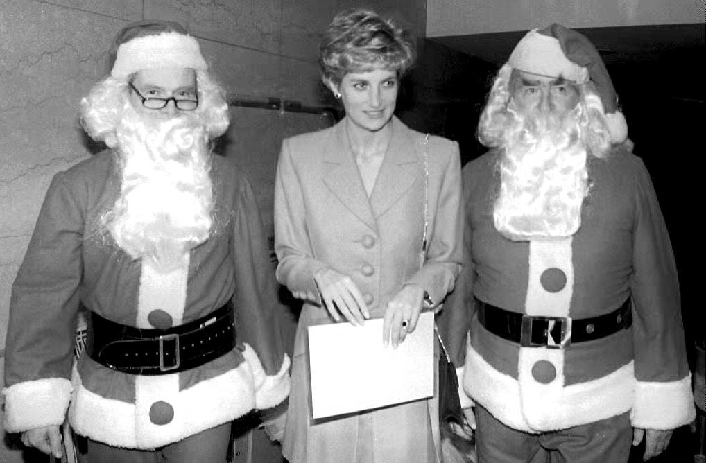 Diana was wedged between two Father Christmases during a charity visit in 1992.