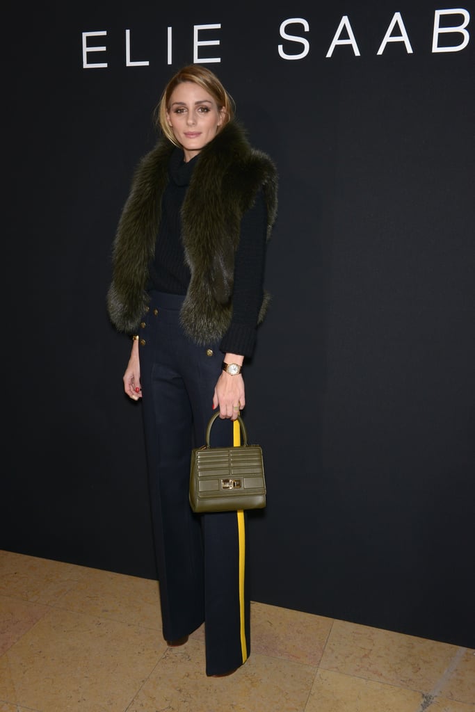 She still kept things fairly feminine though, toting around a small top-handle bag.