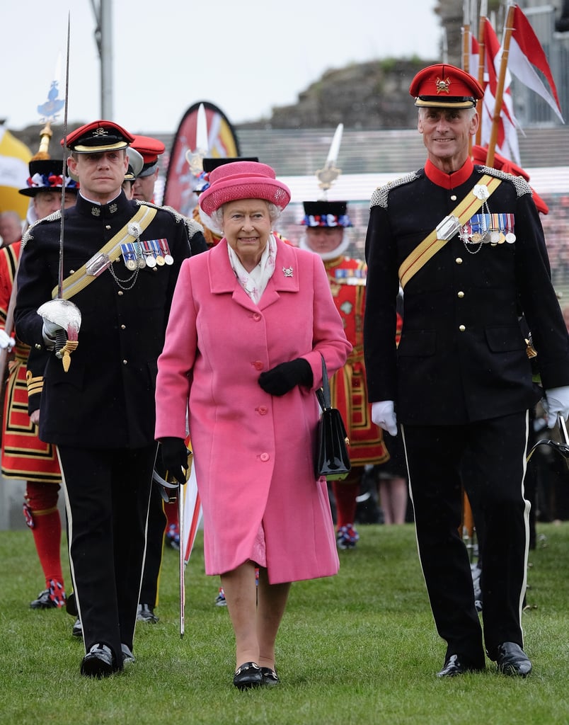 Hours after Kate Middleton gave birth to the new royal baby, a girl, Queen Elizabeth II made an appearance wearing all pink. She had a big smile on her face during the official engagement in Richmond, England, where she watched the amalgamation parade of The Queen's Royal Lancers before speaking to soldiers and their families. Meanwhile, her grandson Prince William was busy introducing his baby girl to the world alongside Kate Middleton. Keep reading for more pictures of the queen's appearance, then see the first photos of the new royal baby plus adorable snaps of Prince George at the hospital!