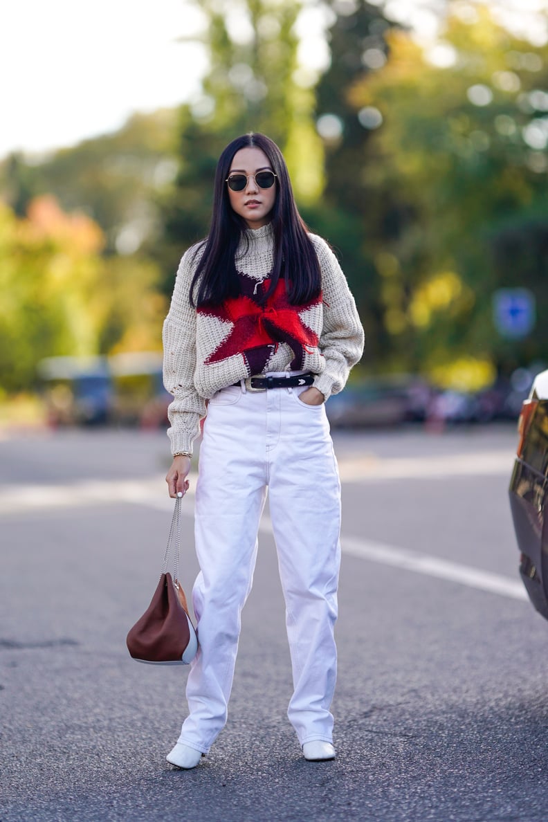 Cap Off Loose, Baggy Jeans With White Heeled Booties, Which Will Elongate the Legs