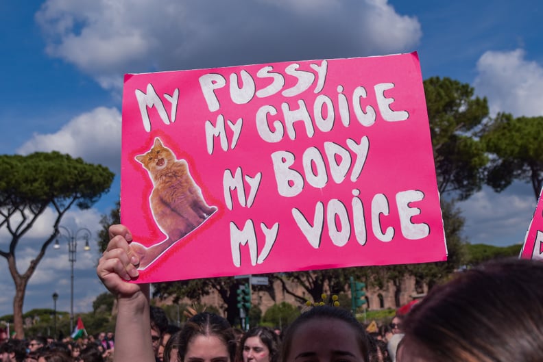 A protester holds a poster that reads, My pussy, my choice, my body, my voice, in Rome, Italy.