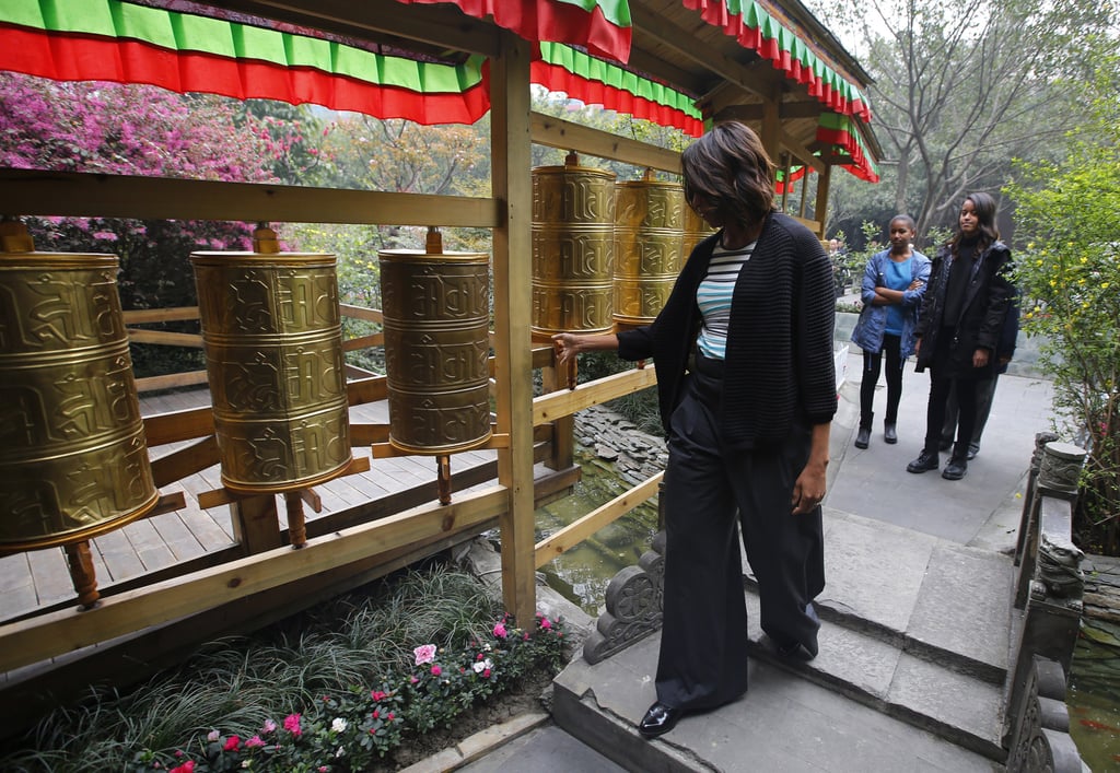 Michelle Obama checked out a Tibetan prayer wheel while at a restaurant in Chengdu.