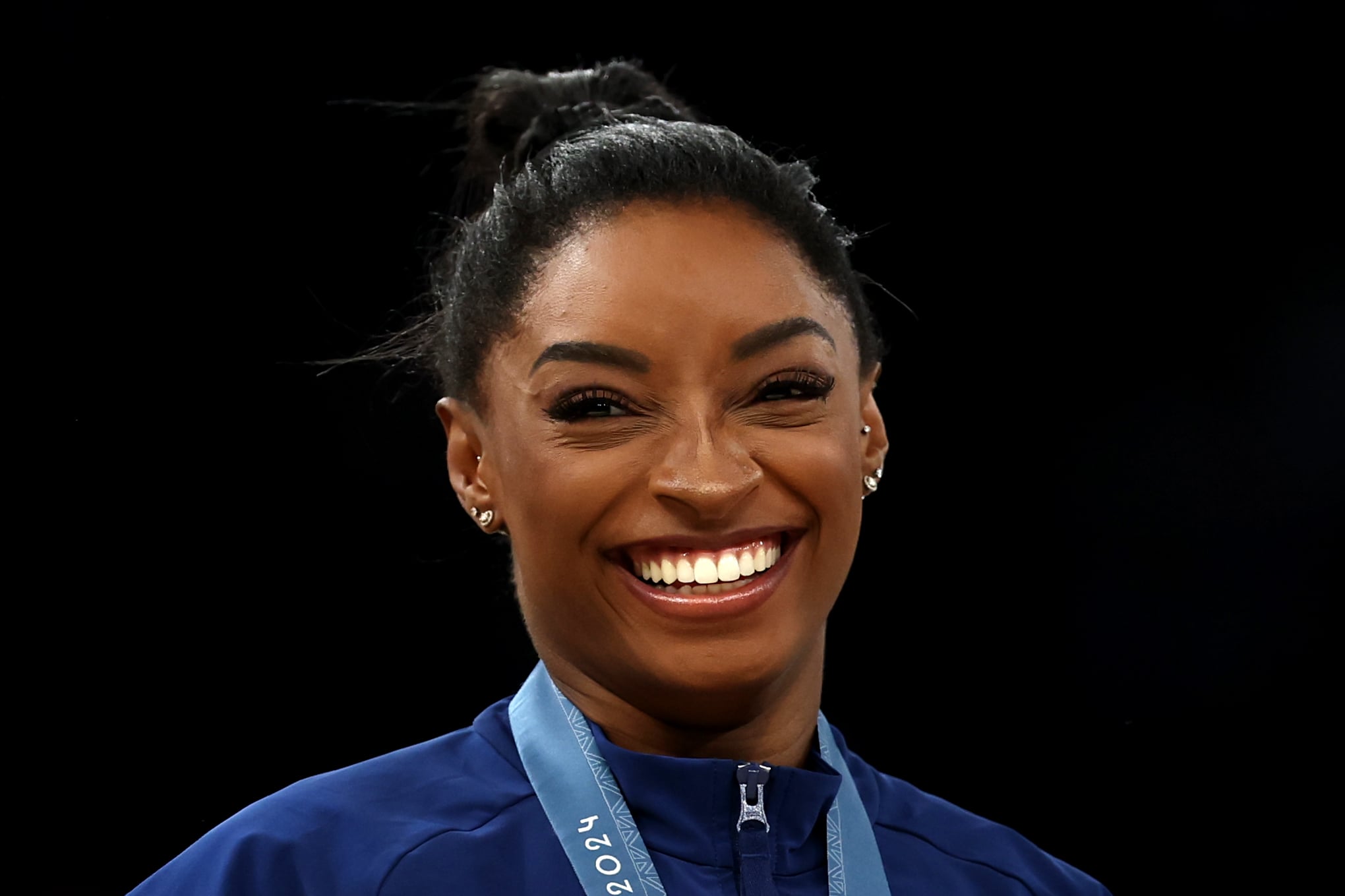 PARIS, FRANCE - JULY 30: Gold medalist Simone Biles of Team United States reacts on the podium during the medal ceremony for the Artistic Gymnastics Women's Team Final on day four of the Olympic Games Paris 2024 at Bercy Arena on July 30, 2024 in Paris, France. (Photo by Naomi Baker/Getty Images)