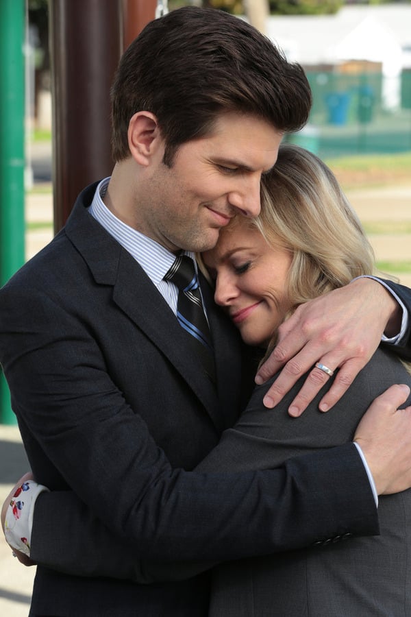 Ben and Leslie embrace, fittingly, in a park.