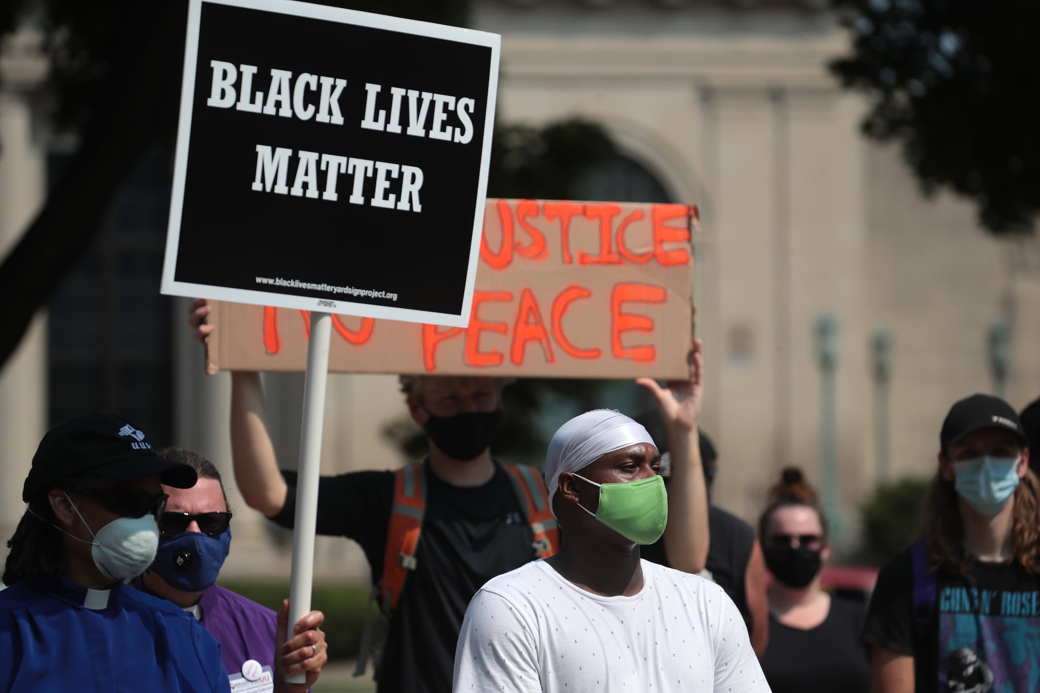 KENOSHA, WISCONSIN - AUGUST 24: A Black Lives Matter sign is held up as people gather in front of the police station the day after a Black man was shot by police causing outrage and local unrest in the city on August 24, 2020 in Kenosha, Wisconsin. Kenosha Police shot a Black man multiple times in the back yesterday night as he entered the driver's side door of a vehicle. The man reportedly identified as Jacob Blake, was hospitalized in Milwaukee in serious condition. (Photo by Scott Olson/Getty Images)