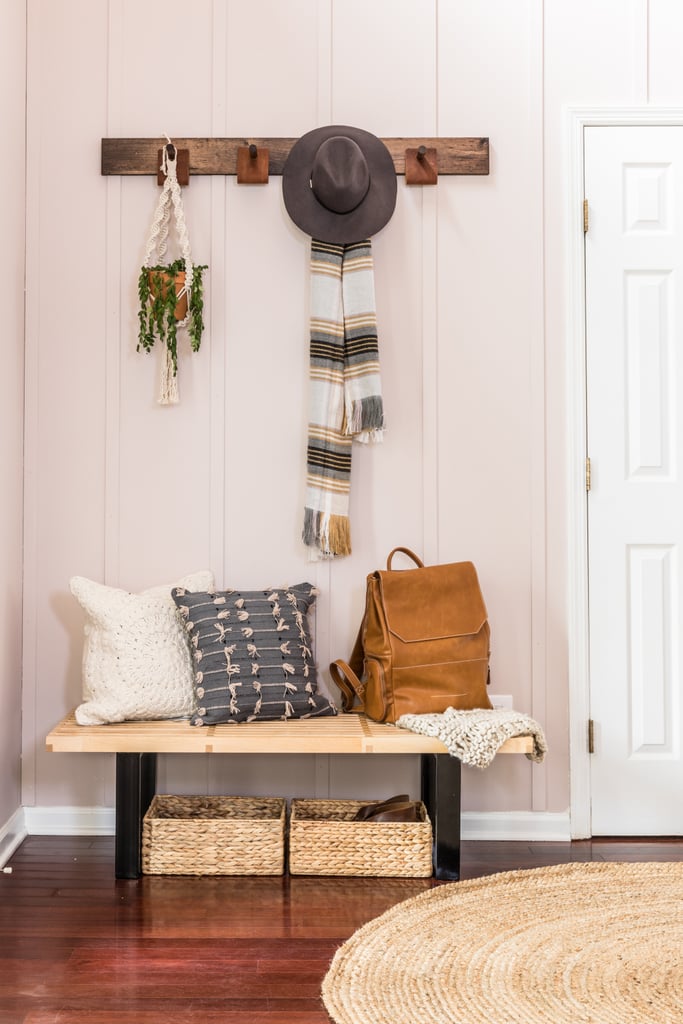Rustic furniture, like a DIY coat hanger and mod wooden bench ($175-$251) covered in soft pillows ($60) make the space both homey and welcoming.