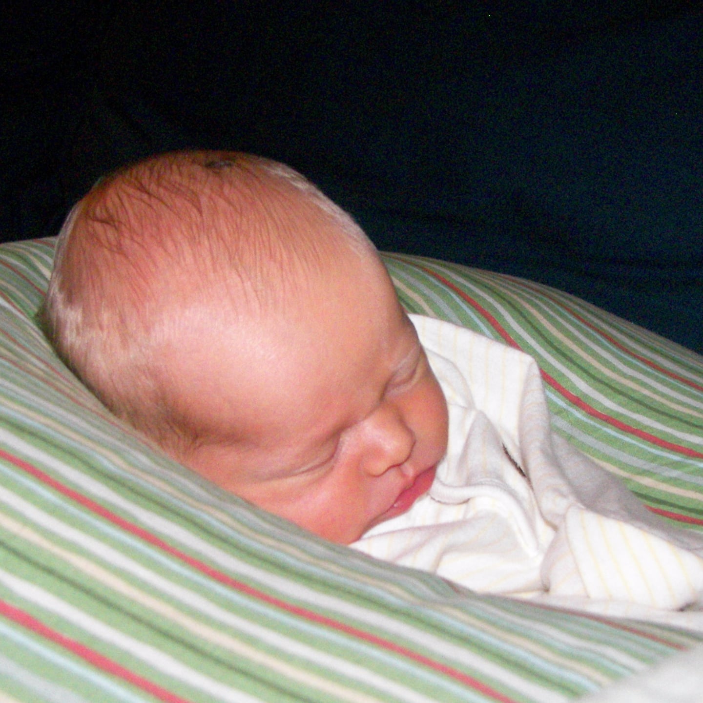 newborn sleeping on boppy pillow