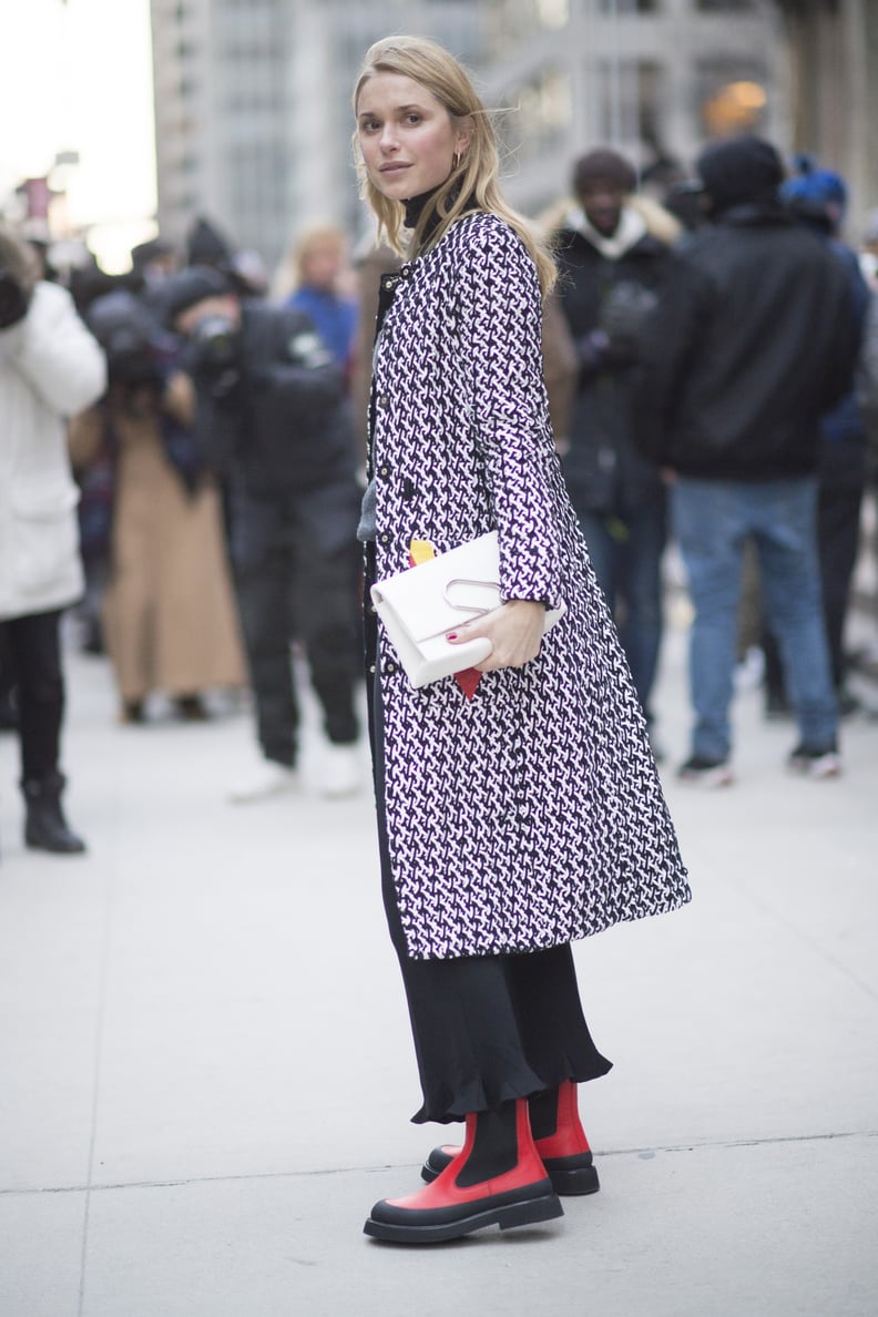 With a Patterned Jacket and Red-and-Black Boots