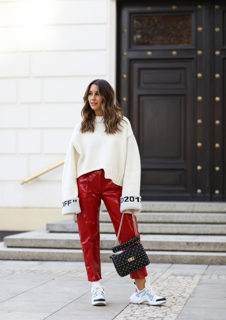 Style an Oversize White Sweater With Bold Red Pants and Designer Sneakers