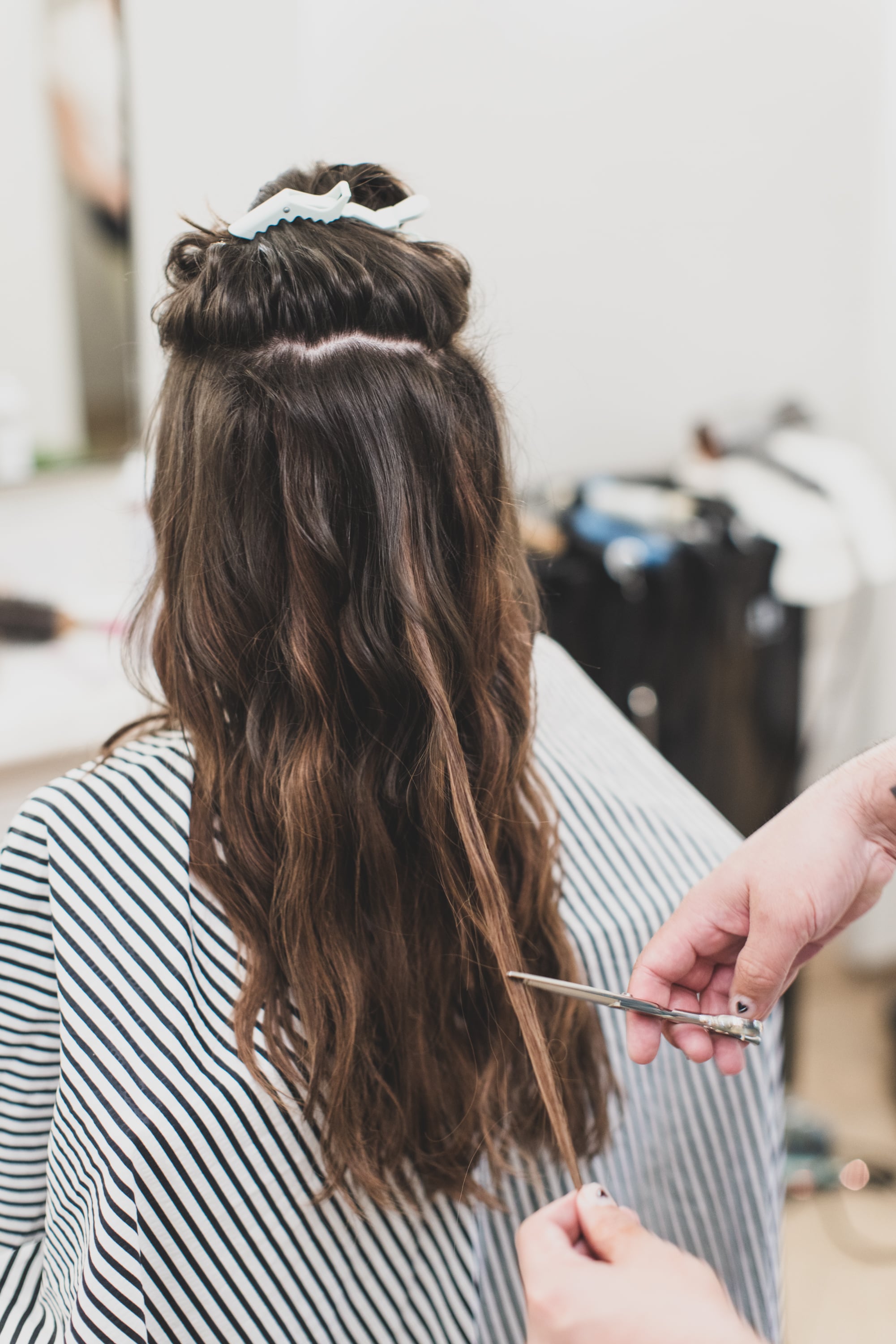 Clayton Hawkins trimming hair extensions for Olivia Rodrigo makeover