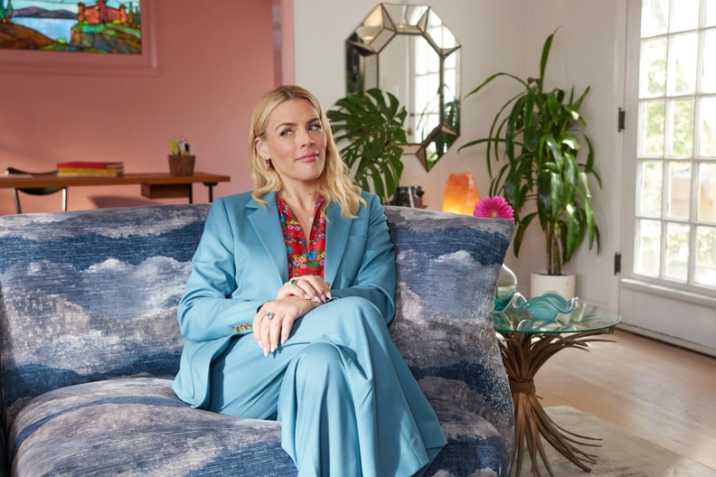 Busy Philipps sitting on the couch in her living room.