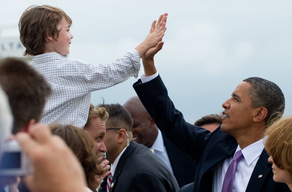 Giving a high five to a child while visiting Kansas City, MO, in 2010.
