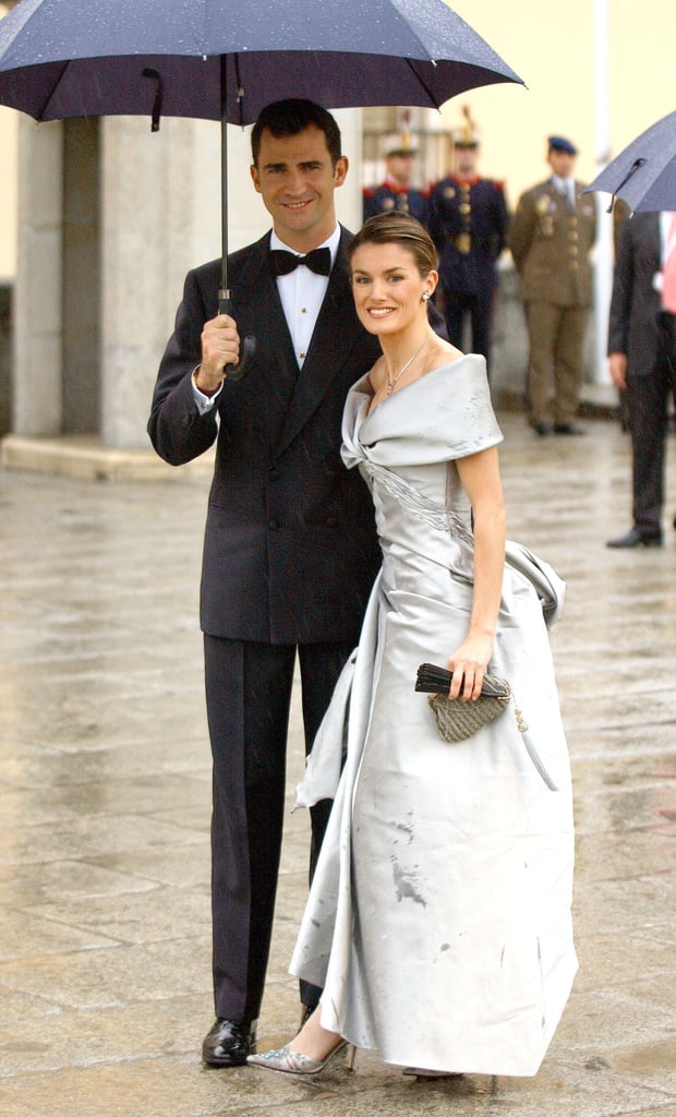 In May 2004, Felipe held an umbrella for his then-fiancée, Letizia, ahead of their wedding.