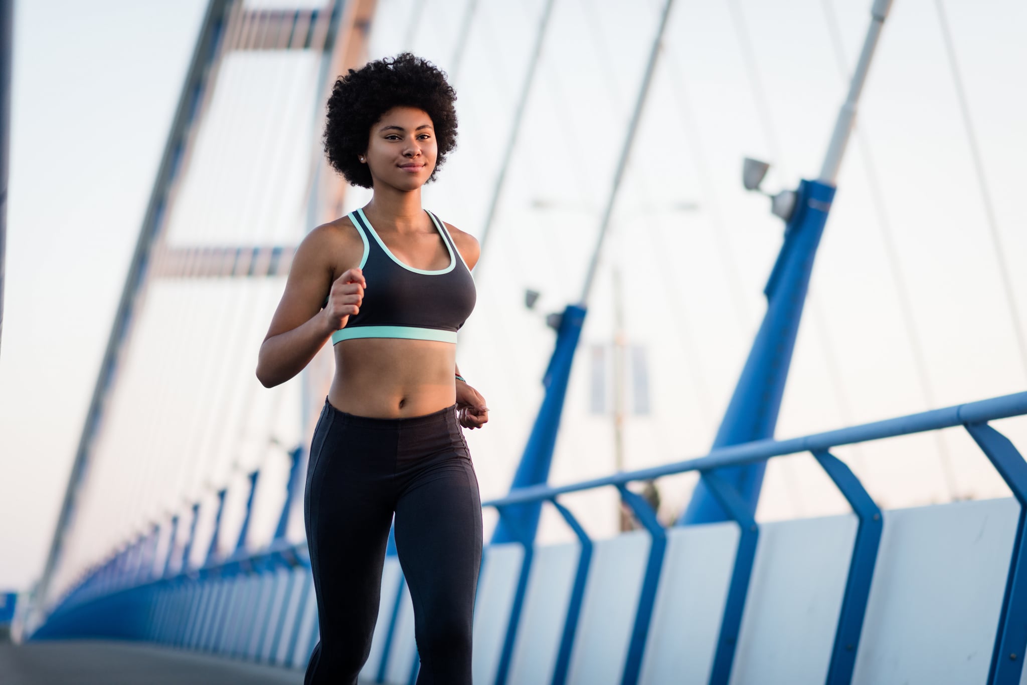 Athlete running on bridge. Healthy lifestyle fitness woman.