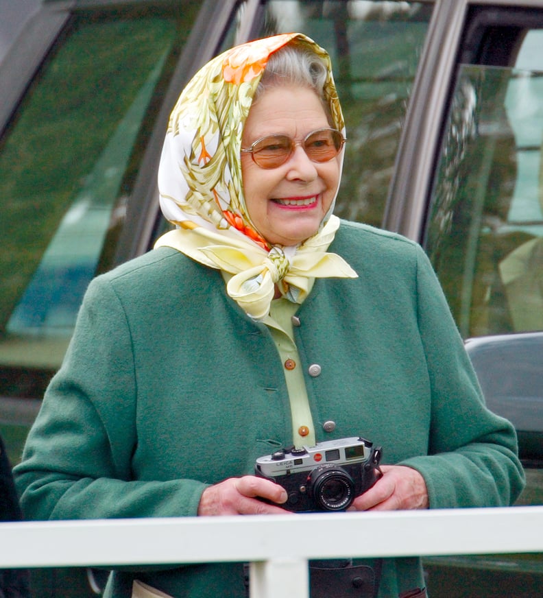 Queen Elizabeth II takes photos of Prince Philip in 2002.