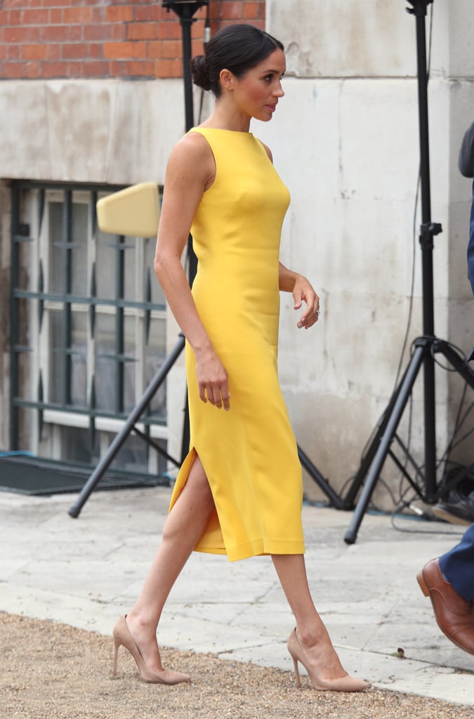 Meghan truly let her bright marigold dress do the talkin', as she simply paired it with neutral pumps and diamond Adina Reyter earrings.