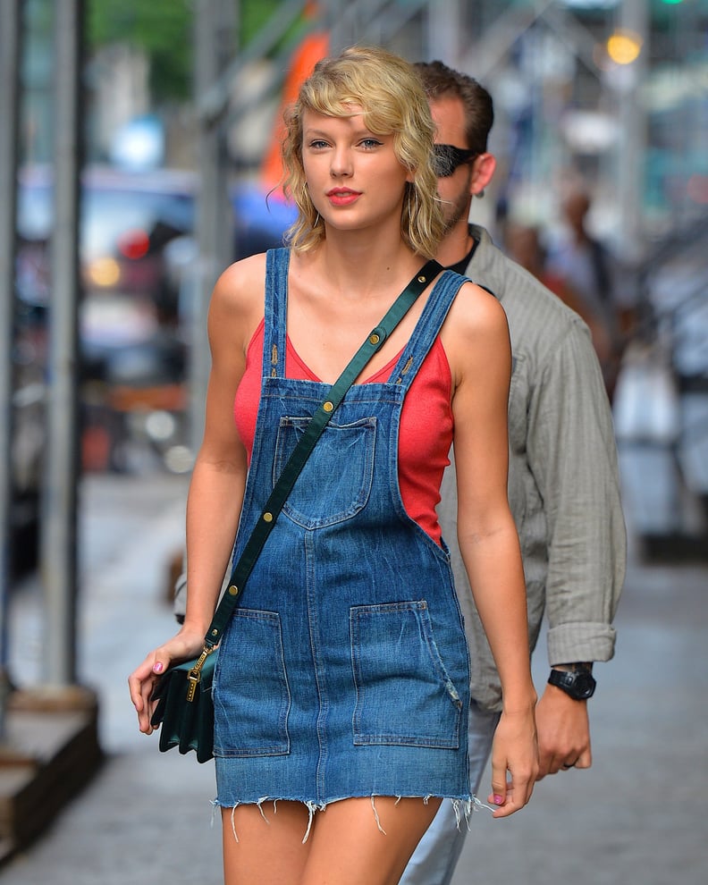 Taylor Swift steps out in a leggy pinafore dress in NYC, sporting kooky bedhead curls