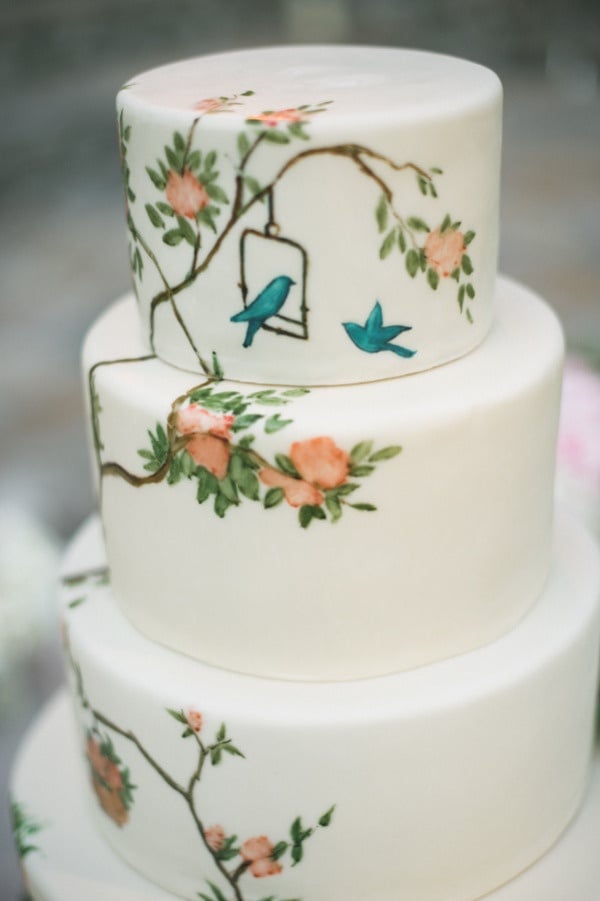 Painted wedding cakes are inherently special, and we think this particular one with its bird and floral design is just fabulous.