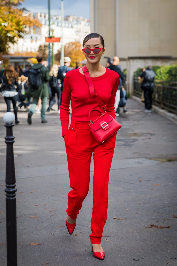 While an abundance of red separates might give off "extreme" vibes, swinging your crossbody bag over the shoulder and going hands free will keep your look relaxed.