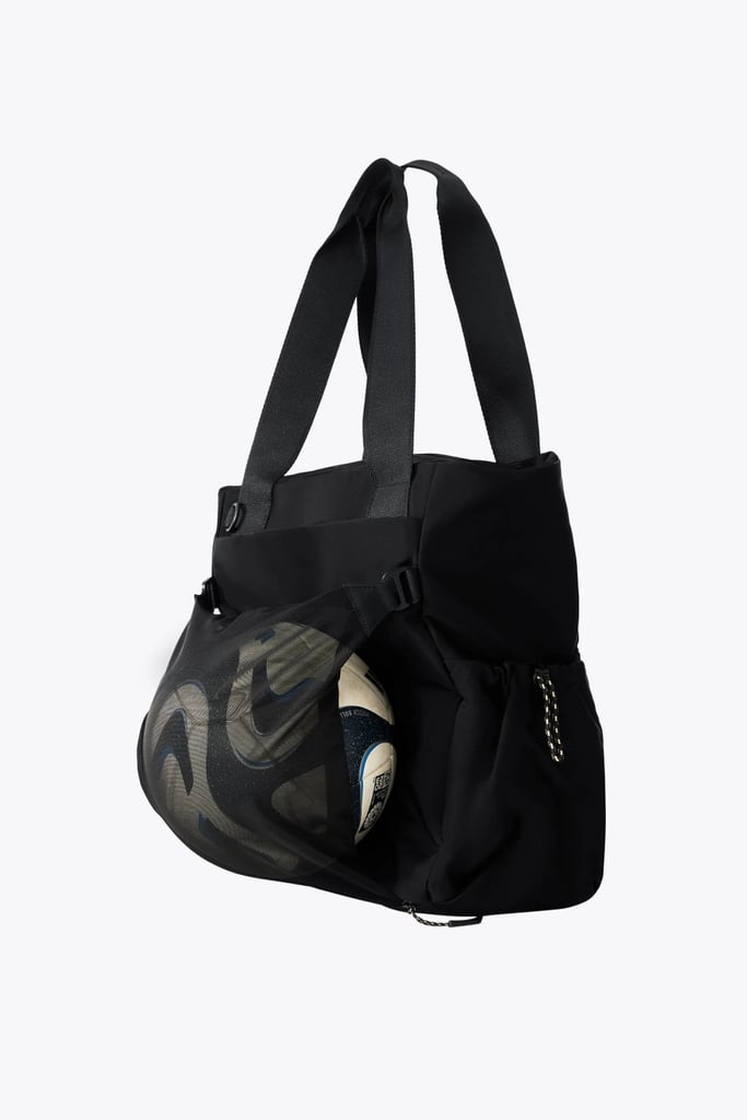 Béis The Sport Tote ($88)
A bag can have all the compartments in the world but if they don't serve a real purpose, they're pointless. This sport tote has been one of my favorite gym bags becuase the design is functional, intentional, and (most importantly) very cute. 
Pros: There are several features that prioritize organization such as a laptop sleeve, mesh catchall, water bottle pocket and a key leash
Cons: The fabric does not have much stretch, making it necessary to be a bit more strategic with your packing
Material: Nylon and Polyester
Dimensions: 15.35" H x 7.48" W x 11.8" L
Colorways: Three
Who It's Best For: The person who needs a bag to keep up with multiple activities in a day 
What Reviewers Say: "This bag is so cute. I bought it specifically for hauling my stuff to tennis lessons. It fits my racket, 40-ounce water bottle, and there's plenty of room to spare. I could see taking it for a short weekend trip because it's so roomy. I absolutely love the outside pocket with the key holder so that I can get to my keys, wallet, and phone quickly. Highly recommend."