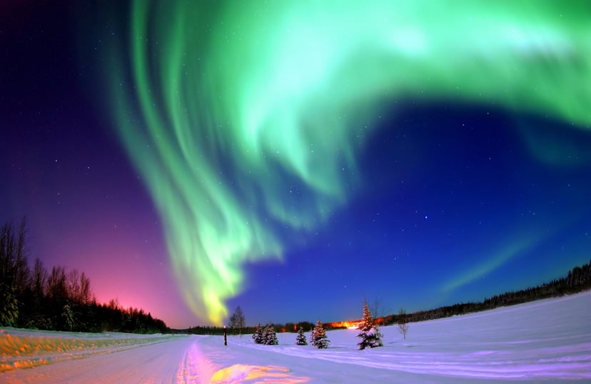Photograph of the Northern Lights, also known as, an Aurora. An aurora is a natural light display in the sky, especially in the high latitude regions, caused by the collision of solar wind and magnetospheric charged particles with the high altitude atmosp