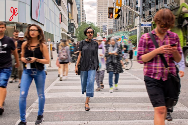 Walking slowly on a busy sidewalk.