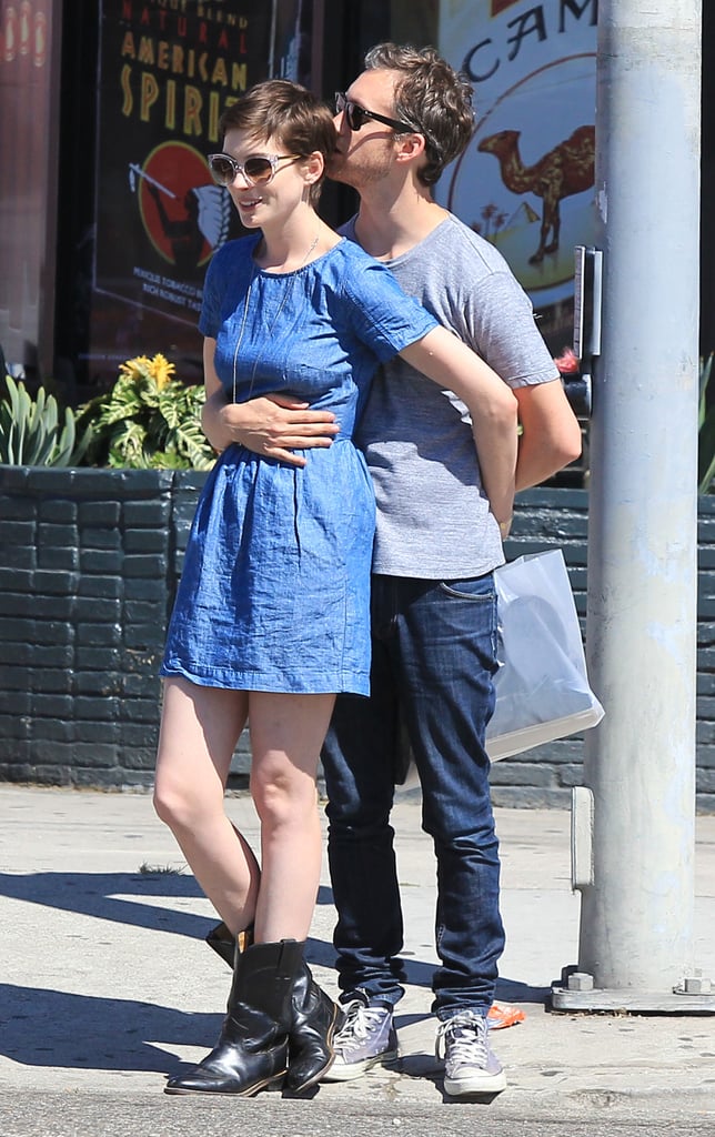 Adam Shulman wrapped his arms around Anne Hathaway during a shopping date in LA in August 2012.