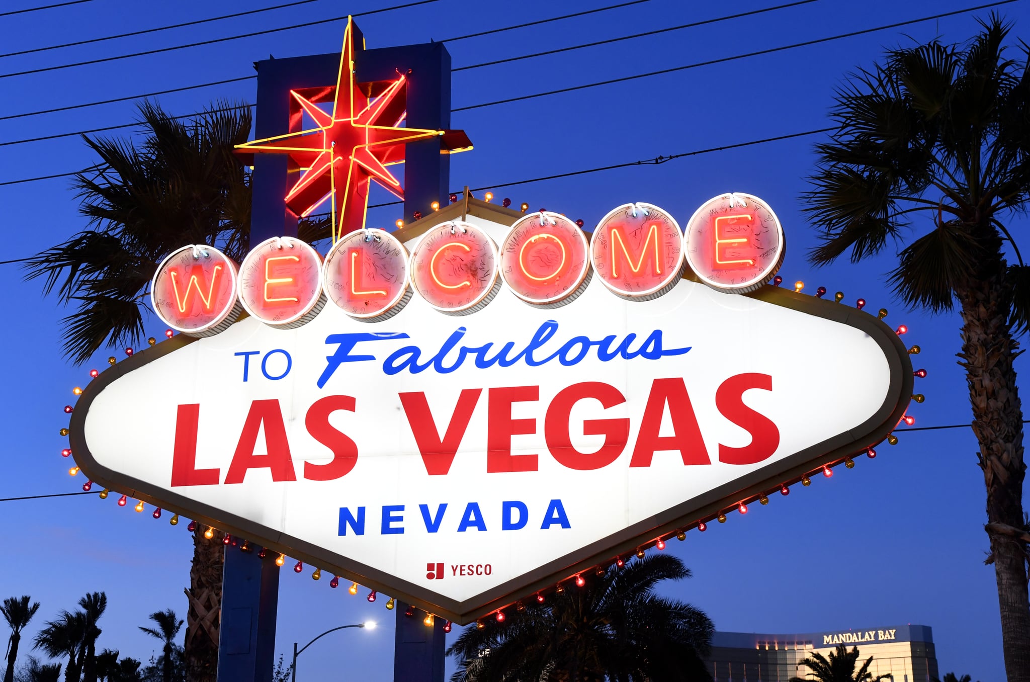 LAS VEGAS, NEVADA - JANUARY 29:  Purple and gold lights flicker around the Welcome to Fabulous Las Vegas sign as a tribute to nine victims killed in a helicopter crash on Sunday in Southern California, including Kobe Bryant and his daughter Gianna Bryant, on January 29, 2019 in Las Vegas, Nevada. Clark County officials switched the lightbulbs to Los Angeles Lakers colors in honor of Kobe Bryant, who played in preseason NBA games in Las Vegas as well as practiced with the USA Basketball Men's National Team in the city ahead of the 2008 and 2012 Olympics.  (Photo by Ethan Miller/Getty Images)