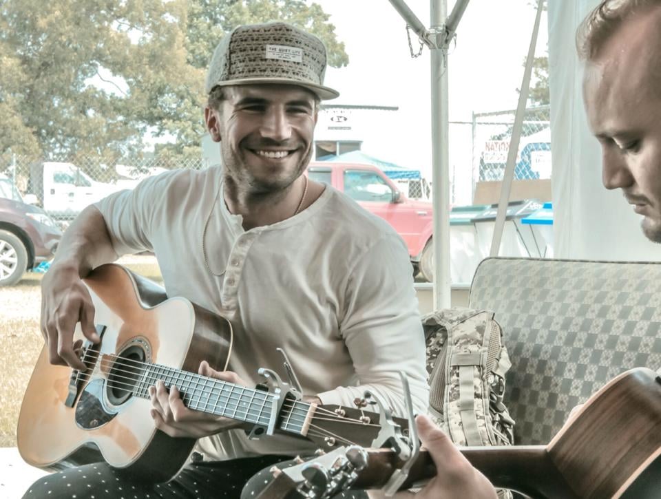 The guitar, that smile — it's almost too much.