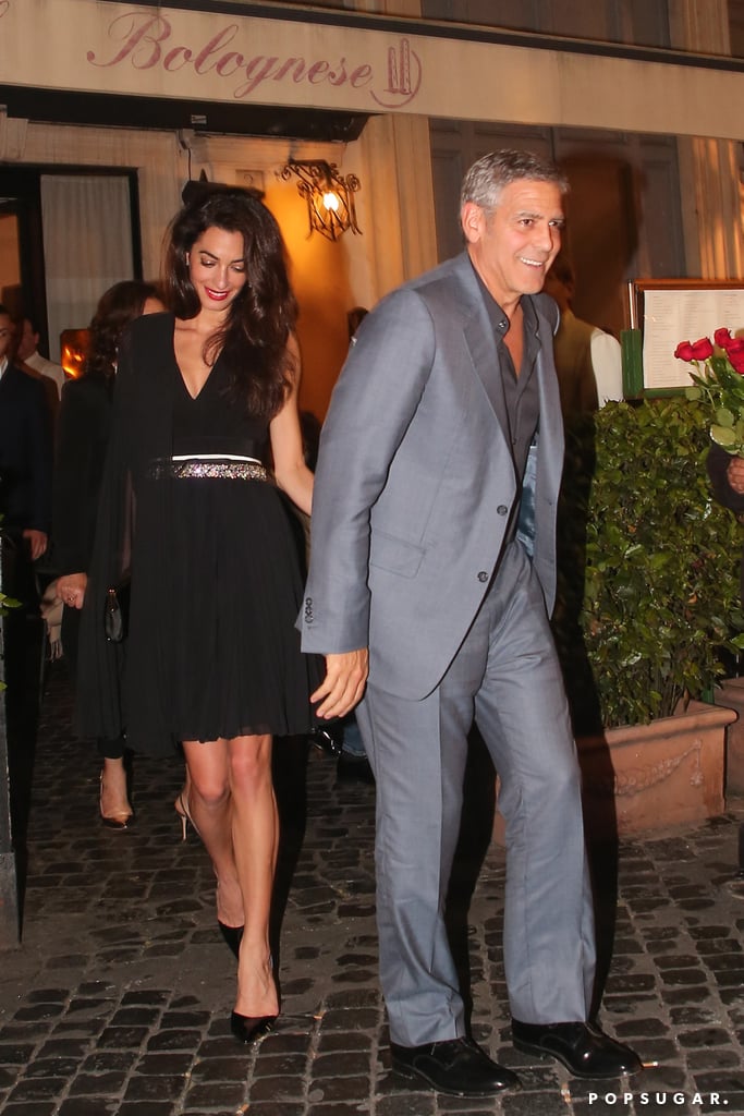 Amal Clooney held on tight to husband George's hand as they stepped out after dinner at Dal Bolognese in Rome on Saturday night. Amal — who was clad in a sexy black dress — flashed her pearly whites as she let George lead the way to their car. The pair's outing comes a little over two weeks after they turned heads with their glamorous appearance at the Cannes Film Festival, at which they linked up with George's longtime pal Julia Roberts and Money Monster director Jodie Foster. While there, Julia opened up about Amal in an interview with ET, saying that she's changed George "in a beautiful way that all wives kind of have a beautiful, loving influence over their husbands." Keep reading to see more of the duo, then relive 21 times George and Amal looked madly in love.