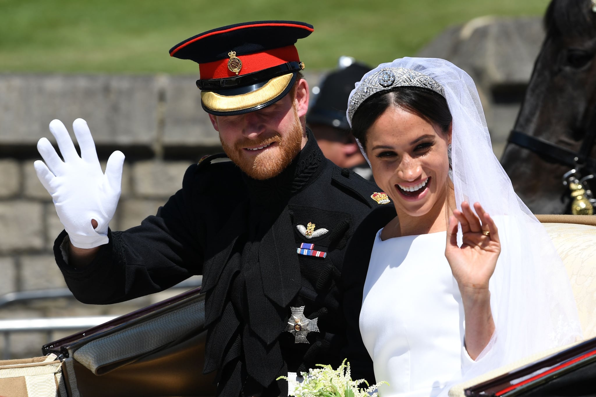 Britain's Prince Harry, Duke of Sussex and his wife Meghan, Duchess of Sussex wave from the Ascot Landau Carriage during their carriage procession on Castle Hill outside Windsor Castle in Windsor, on May 19, 2018 after their wedding ceremony. (Photo by Paul ELLIS / various sources / AFP)        (Photo credit should read PAUL ELLIS/AFP/Getty Images)