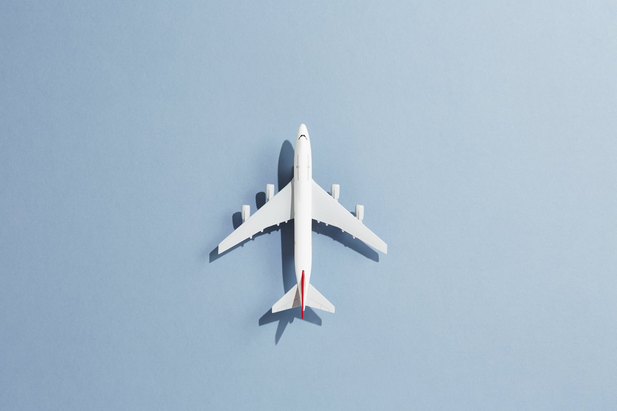 a toy airplane against a blue backdrop