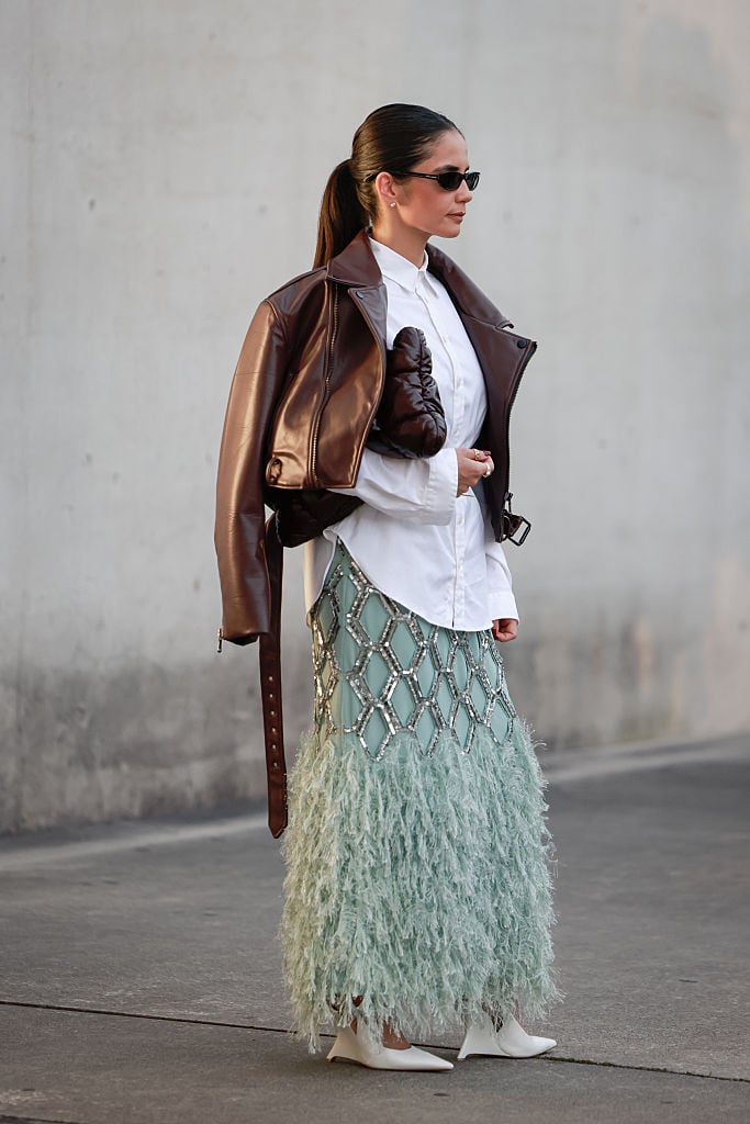 Another show guest tapped into the feather trend, pairing hers with a brown leather jacket.