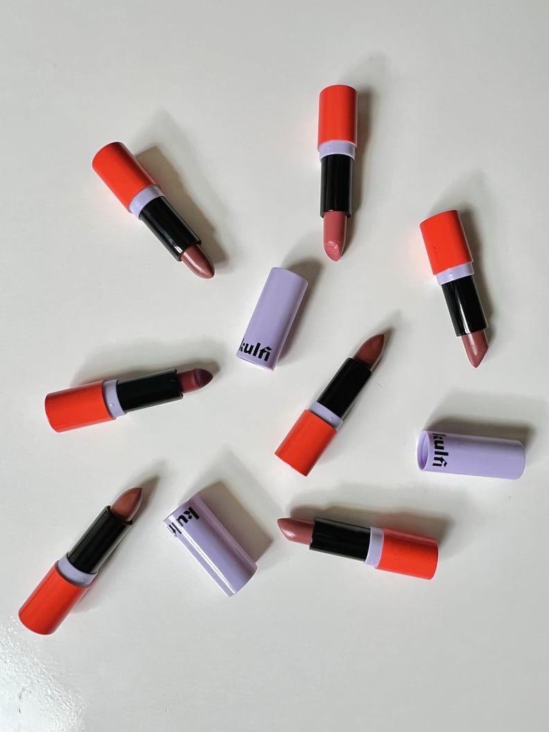 All seven of the Heirloom Satin Lipsticks on white table.
