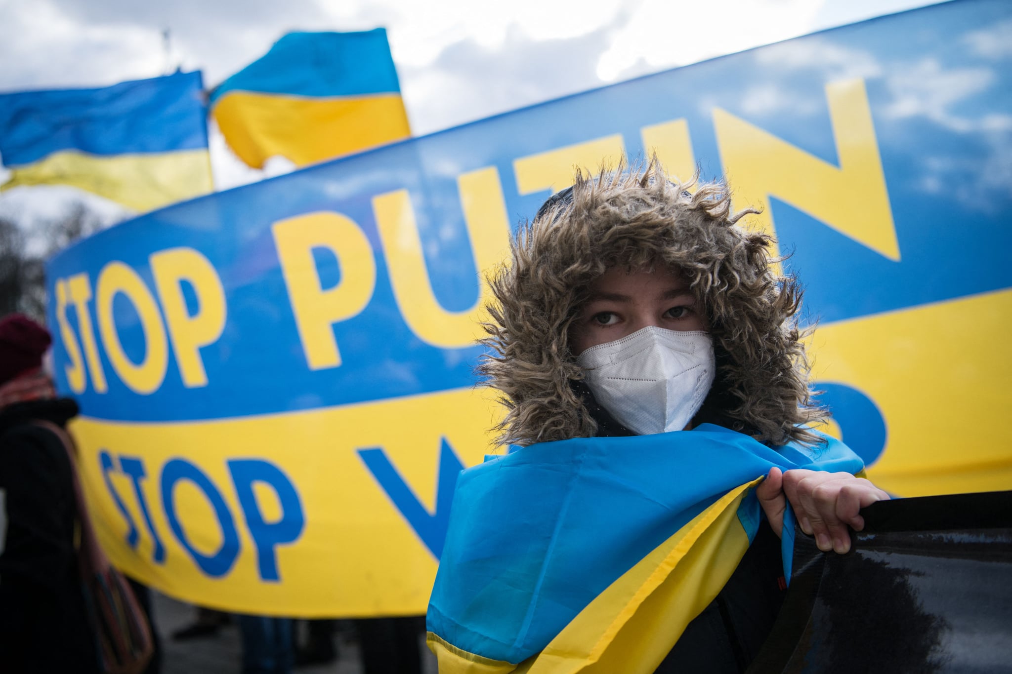 TOPSHOT - A protester stands in front of a banner reading 