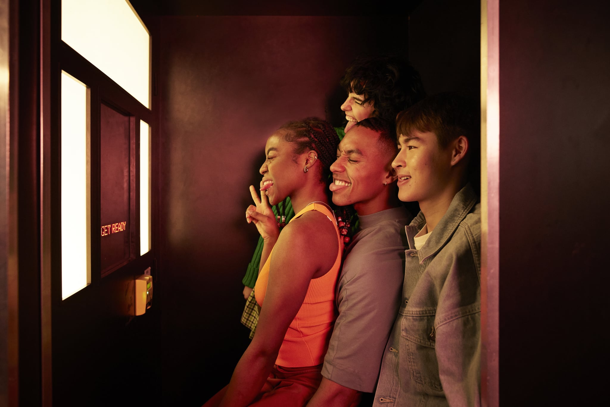 a group of friends inside a photo booth