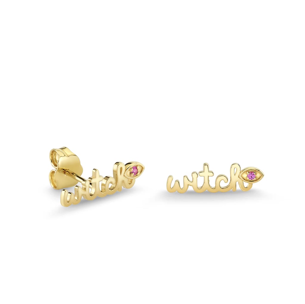 Sydney Evan Gold & Pink Sapphire Wicked Witch Script Stud ($510)
Add one of Sydney Evan's gorgeous jewelry pieces to your repertoire with a limited-edition pair of earrings themed around "Wicked: For Good." These elegant 14K gold studs feature a charming "witch" design and a pink sapphire eye that adds a touch of whimsy.